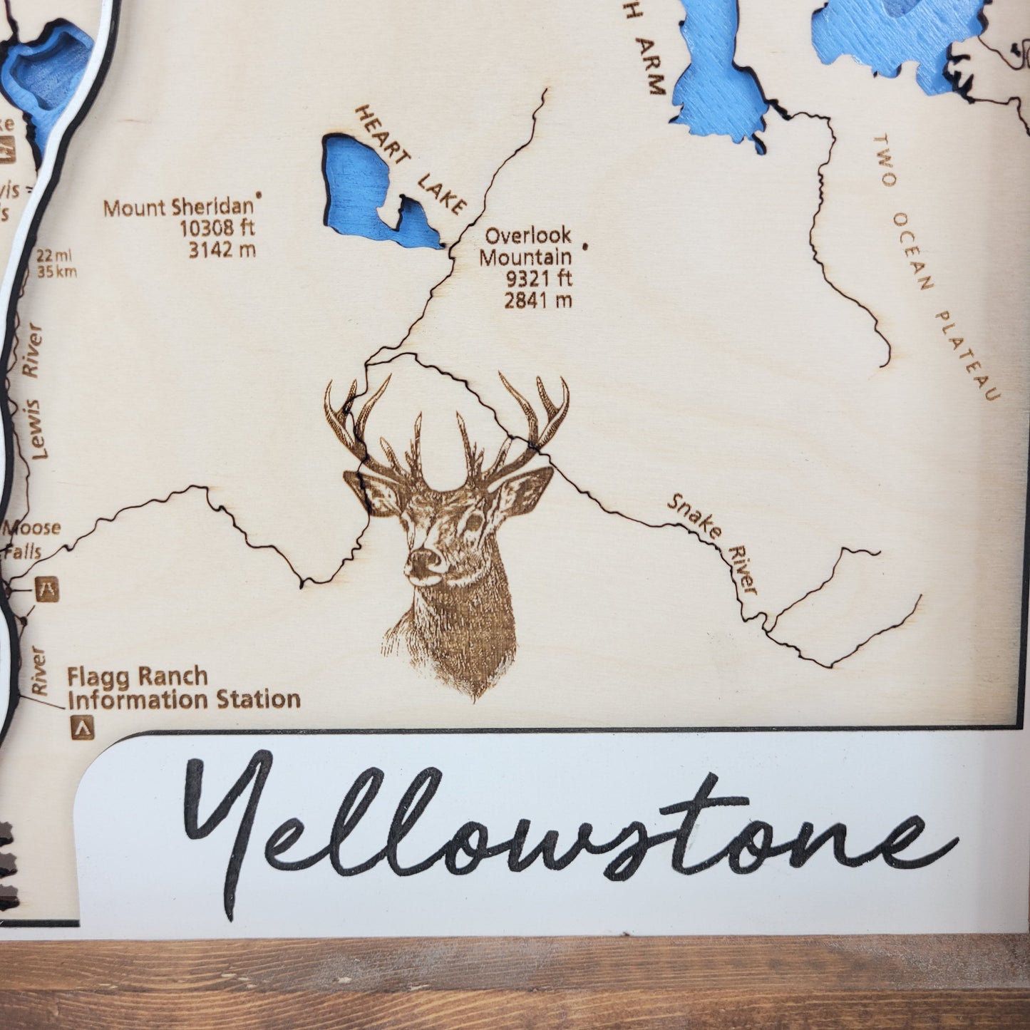 Yellowstone National Park close up of trail names and wildlife details, with title and lake names